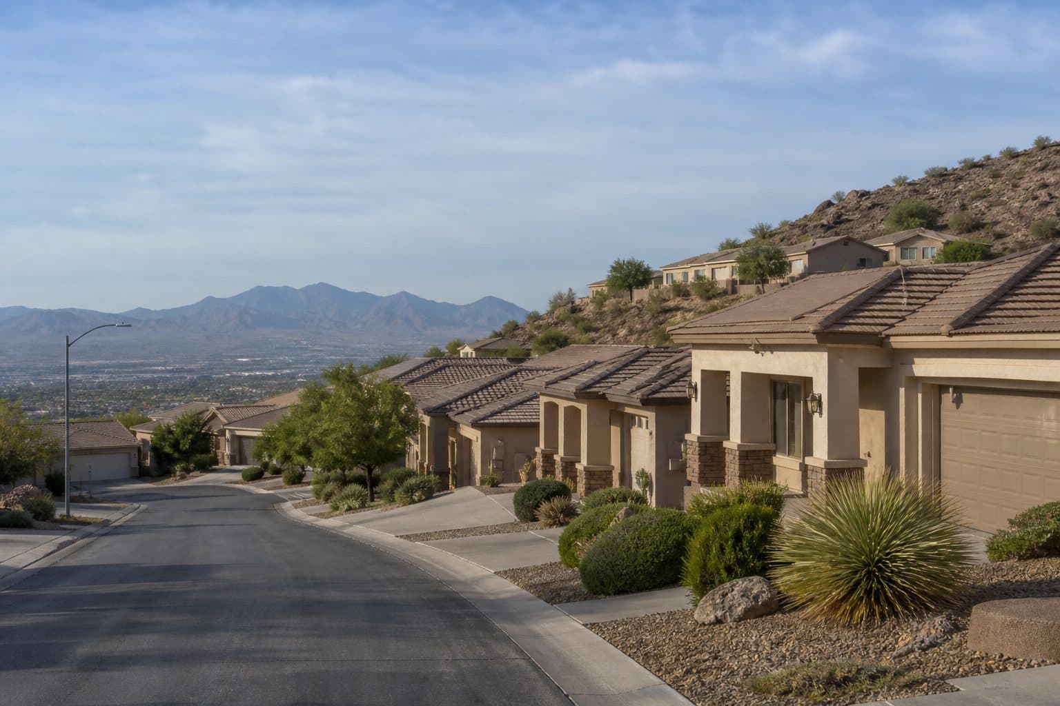 Henderson hillside street of single-level stucco homes with a covered front walk.