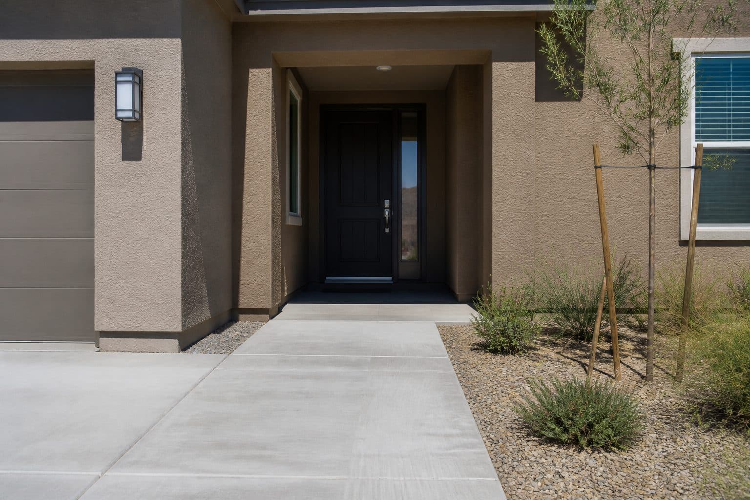 Arrival route from driveway to front door with no stair and a shallow threshold.